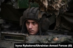 A Ukrainian tank driver speckled with mud at an undisclosed location in October