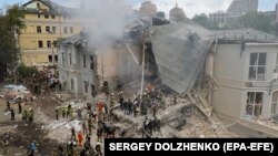 Ukrainians work at the site of a missile strike on a children's hospital in Kyiv on July 8.