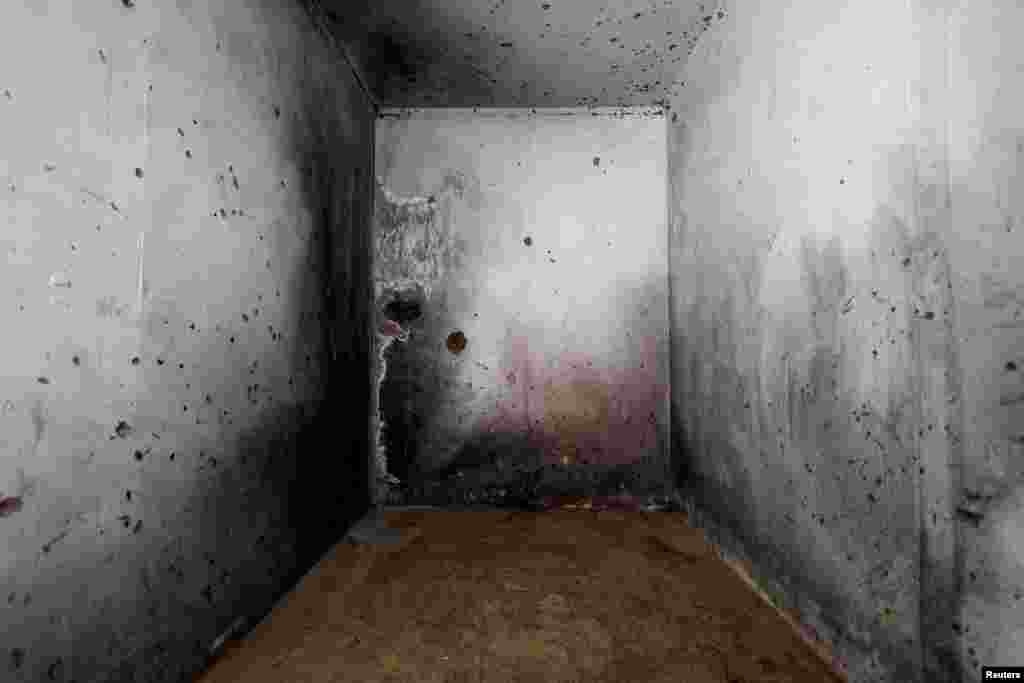 Bullet holes and blood stains mark the walls of a bomb shelter at the Mefalsim Kibbutz in southern Israel. Several people who had sought refugee here were slaughtered by Hamas militants during the October 7 attack.