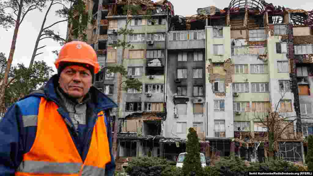 A construction worker looks on in a damaged residential area of Irpin on April 4. Irpin&#39;s reconstruction is expected to cost about $685 million, according to ReBuildUA. &nbsp;