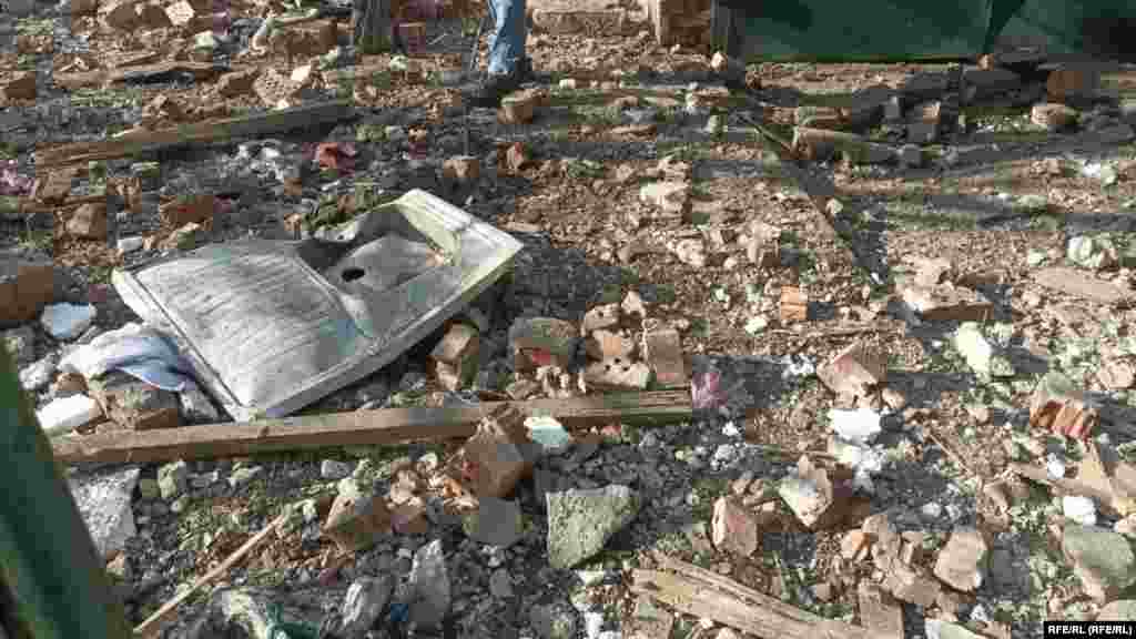 A person walks through the rubble near a residential area that was damaged during the missile strike. 