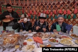 Birders partake in traditional Kazakh food during a break between competitions.