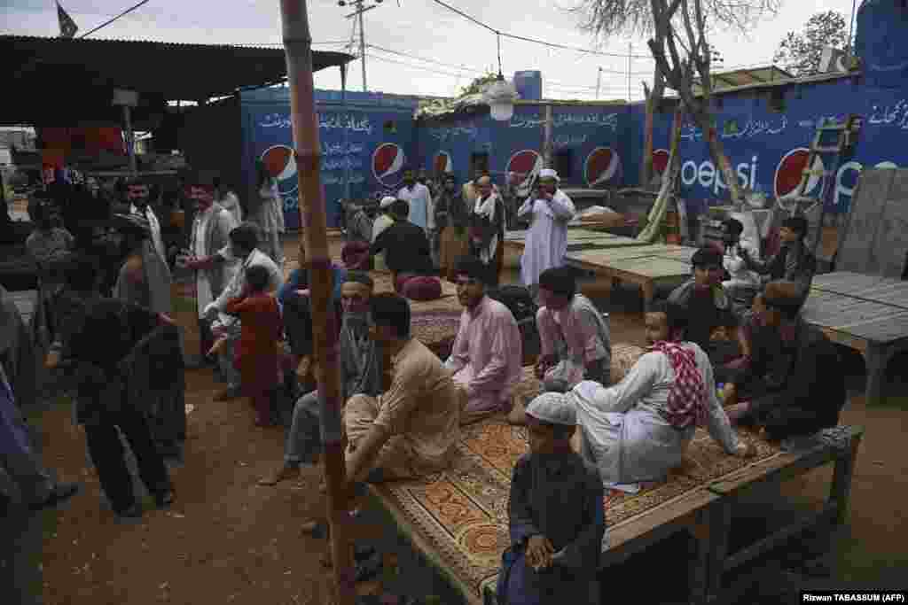 Afghans gather at a tea shop in the refugee camp in Karachi. Afghans have poured into Pakistan in their millions during decades of successive wars, many living in aid camps with restricted access to education, health care and employment.&nbsp;