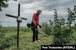 A Polish volunteer maintains the cemetery where deported Poles and their descendants are buried.