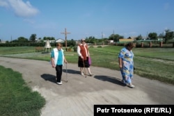 Women walk to the parish church.