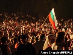 A man holds a Bulgarian flag ahead of the bonfire lighting on August 19.