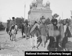 Armenian soldiers bring in a group of men described as "deserters from the Armenian army," in Yerevan.