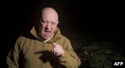 Yevgeny Prigozhin is shown in a video addressing the Russian Army's top brass standing in front of bodies he presented as fallen Wagner fighters at an undisclosed location in Ukraine in early May.