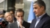 International Atomic Energy Agency (IAEA) Director-General Rafael Grossi (center) looks on during a news conference with the head of Iran's Atomic Energy Organization, Mohammad Eslami, as they meet in Tehran in March 2022. 