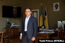 Zhytomyr Mayor Serhiy Sukhomlyn, shown in his office, says the city is already warming two schools with straw.