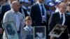 Russian President Vladimir Putin (right) holds a portrait of his father as he takes part in the Immortal Regiment march in Moscow on May 9.