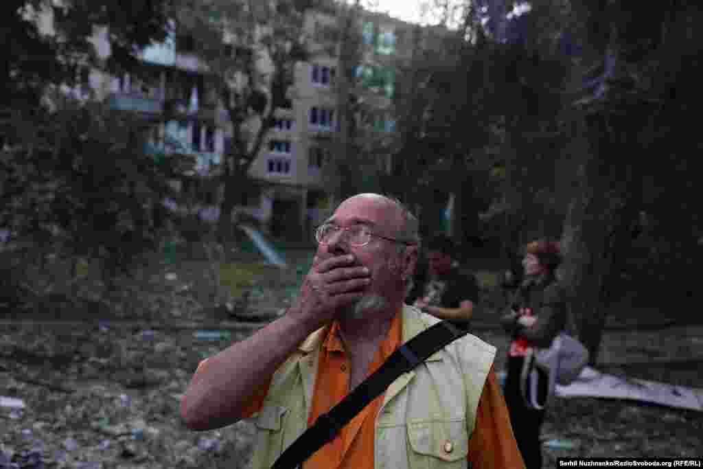 A man reacts to the sight of a destroyed apartment block in Kyiv on the morning of June 17. 