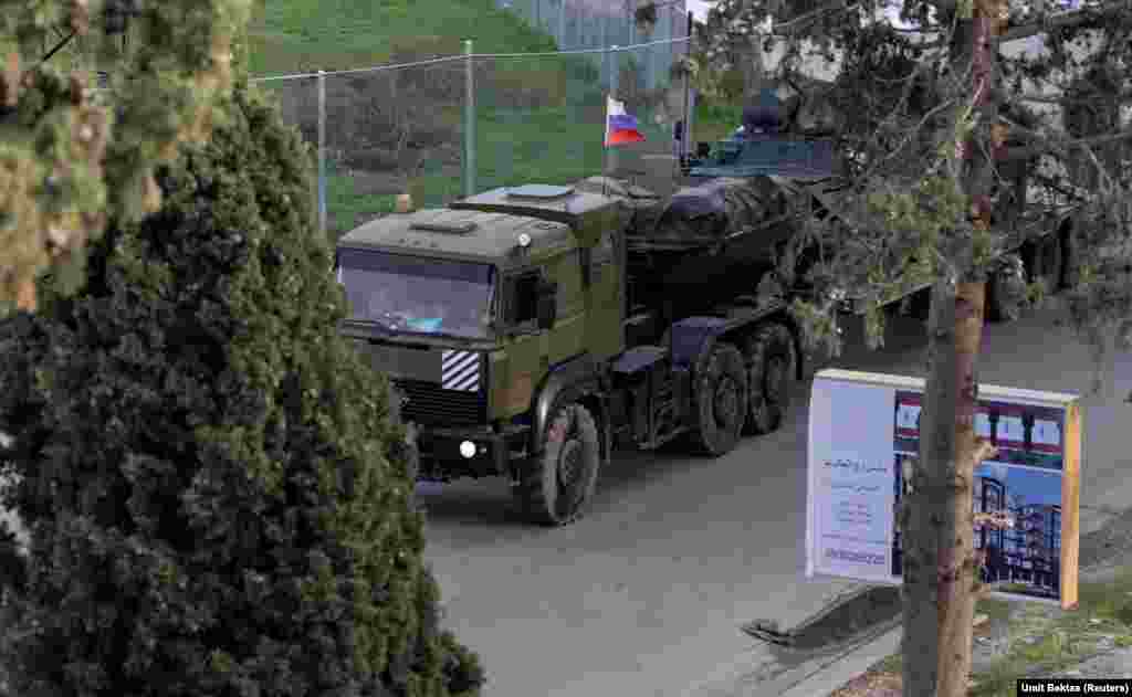 A Russian military vehicle nears an entrance to the Hmeimim air base in western Syria on December 15. This photo is one of several recent images around the Russian base taken by Umit Bektas, a Turkish photojournalist working for Reuters who spoke to RFE/RL about the situation around the military facility. 