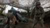 Ukrainian servicemen fire a self-propelled howitzer towards Russian troops near the frontline town of Pokrovsk