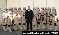 Russian President Vladimir Putin (center) poses with participants in celebrations to mark the Battle of Stalingrad during a visit to the Russia-My History museum in Volgograd in February 2018.