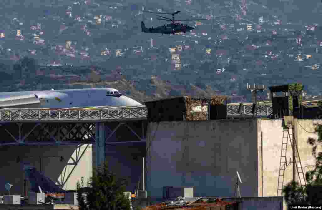 A Russian attack helicopter patrols the Hmeimim air base. Bektas says it is unclear whether the influx of Russian troops to the Hmeimim base from positions elsewhere across Syria will remain there, or whether they are awaiting an airlift out of Syria. 