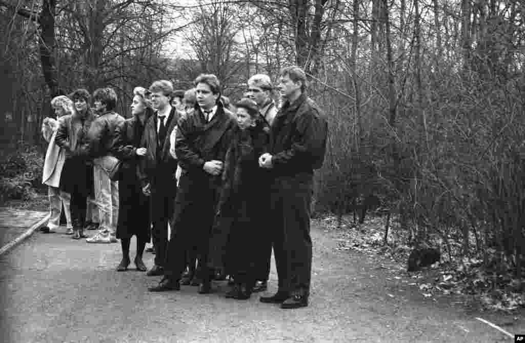 Relatives of Chris Geoffroy, including his mother, Karin (front right), attend his funeral in East Berlin. Geoffrey was the last person to be shot dead while trying to flee East Berlin after making a dash for the wall in February 1989. The Berlin wall came down, effectively ending the reign of the East German communist regime, on November 9, 1989. 