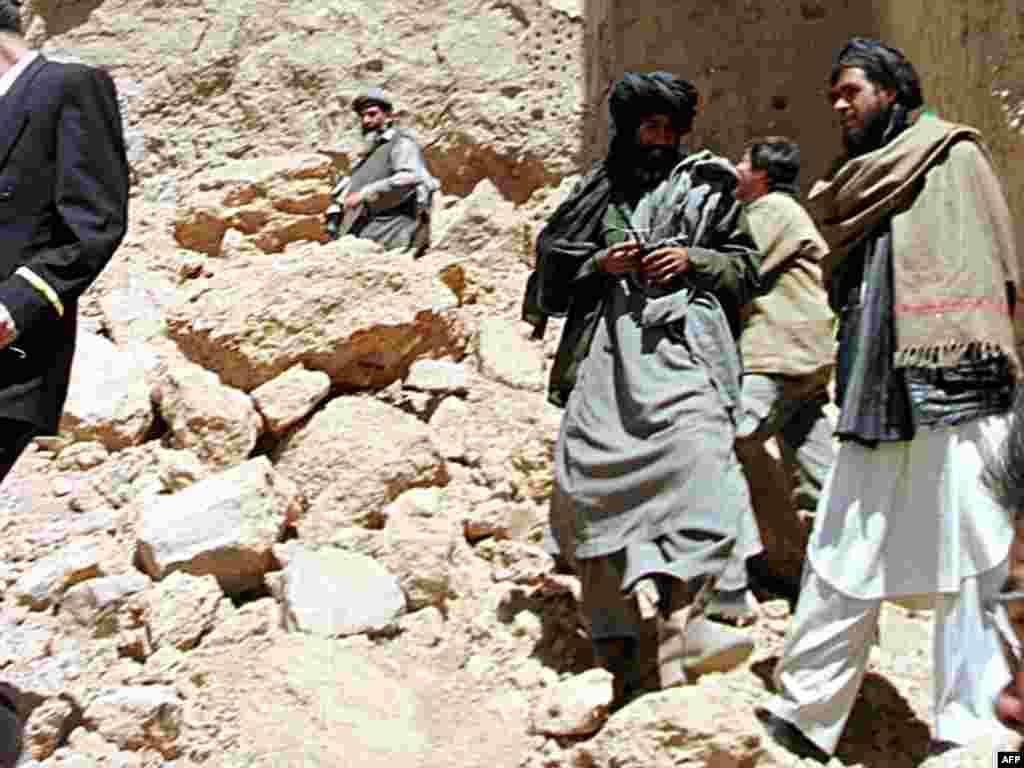 Taliban militants stand amid the rubble of the destroyed treasures on March 26, 2001.