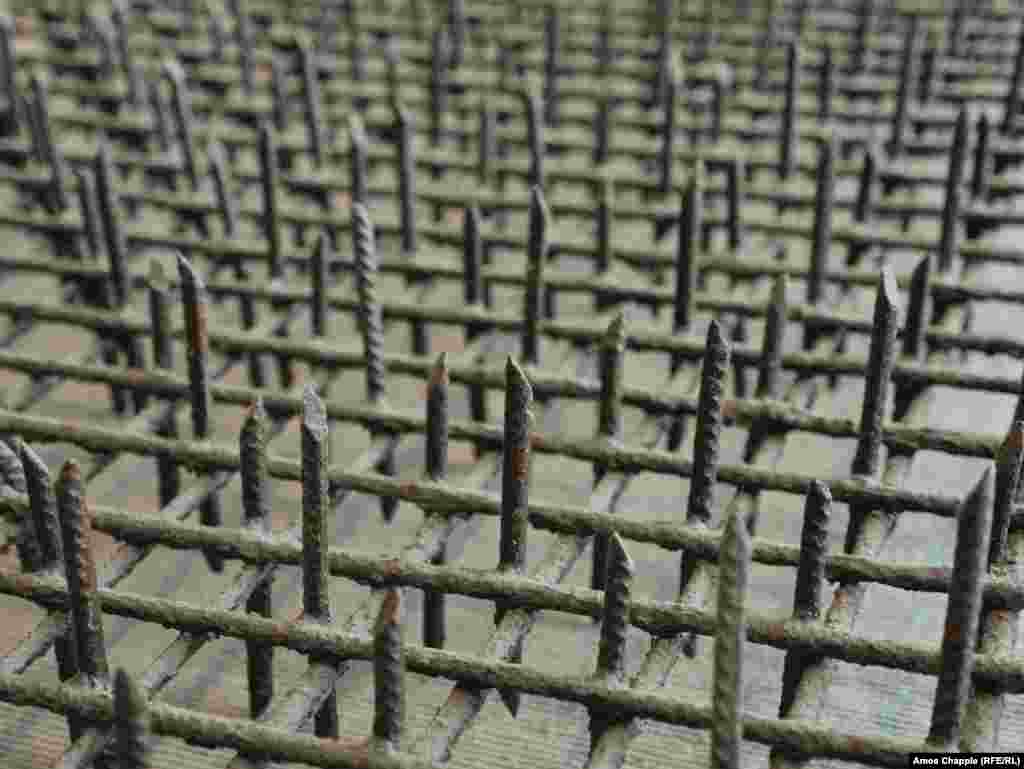This grid of sharpened rebar was one of countless such grates placed alongside the Berlin Wall from the mid-1960s, designed to pierce the shoes of fleeing East Germans. This section of "Stalin's Lawn" has been preserved in a museum of the The Berlin Wall Foundation. 