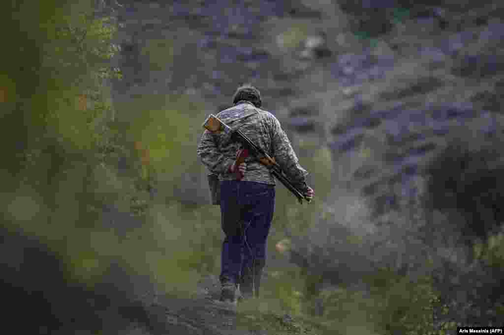 A volunteer fighter strolls near a village south of Stepanakert. In early October, a volunteer fighter told AFP: "We are a small nation and we don't have any other alternative but to win. This is why everyone needs to fight."