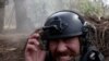 RFE/RL correspondent Maryan Kushnir reacts as Ukrainian forces fire artillery toward Russian positions near Kupyansk in the Kharkiv region. 