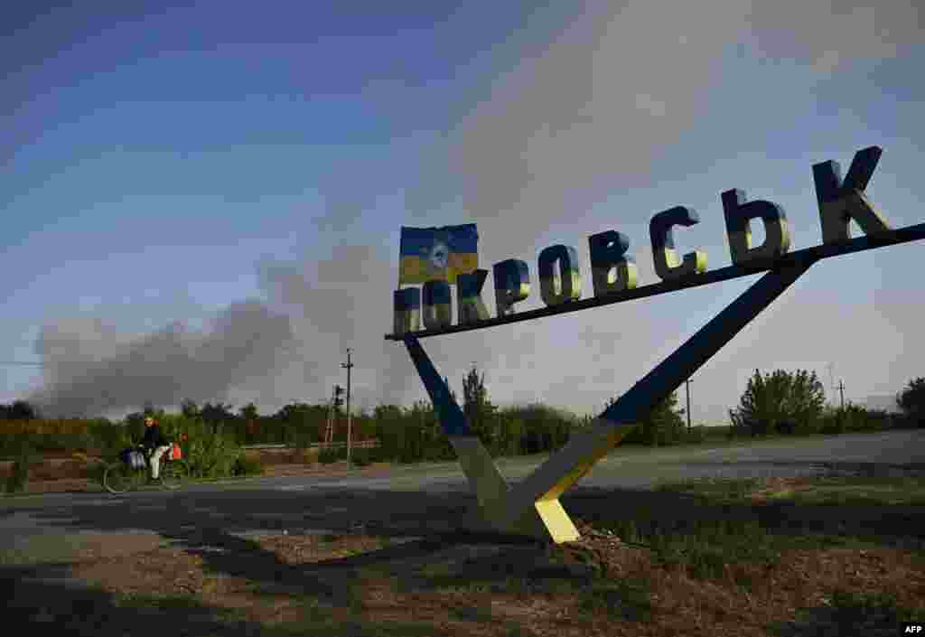 A man rides past the entrance sign on the outskirts of Pokrovsk in September 2024. Since July, Russian forces have been pushing directly toward Pokrovsk, which was once home to some 60,000 people and is seen as a gateway to the Donetsk region. 