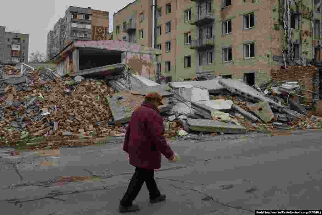 "We live, we keep hoping,” Valentyna Vasylivna (pictured) tells us as she walks through her war-damaged city. “I have a pension of 2,700 hryvnias ($65) per month. Where would I go? My apartment walls keep me warm, this is my home.”