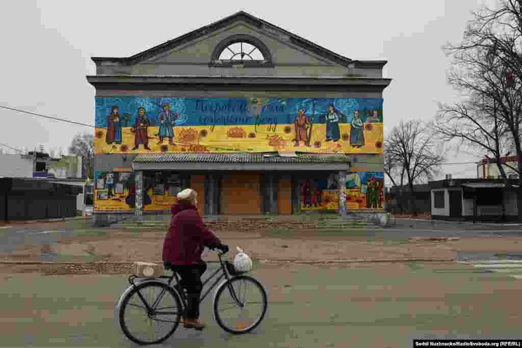 A woman rides past a cinema with a banner declaring “Pokrovsk -- the strength of the Cossack clan.” A curfew is in place in Pokrovsk from three in the afternoon until 11 a.m. the next day. As soon as the curfew is lifted we park our car and walk through the city streets. Only a handful of people are out and about. In the background, artillery can be heard working to the south and east, where Russian forces are advancing from both directions.