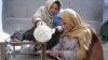 Afghan women begin weaving a carpet in Kabul. Some entrepreneurs have built on traditionally female trades to develop thriving businesses.