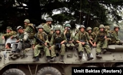 Russian soldiers on a military vehicle leave a base in the western Georgian city of Senaki on August 19, 2008.