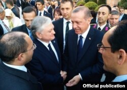 Turkish Prime Minister Recep Tayyip Erdogan (center right) talks to Armenian Foreign Minister Edward Nalbandian during his inauguration in Ankara in August 2014.