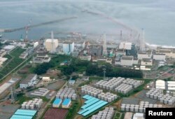 An aerial view of the Fukushima plant and its contaminated-water storage tanks (bottom)