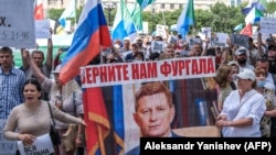 People carry a banner reading "Return Furgal to us" during a rally in support of Sergei Furgal in Khabarovsk on August 8.