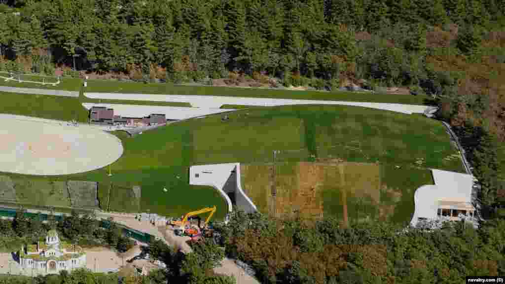 Navalny claims this grassy mound, next to the property's helicopter landing pads, conceals an ice hockey rink. 