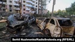Burned-out cars lie strewn across a street on June 23 following a Russian strike on Kyiv. 
