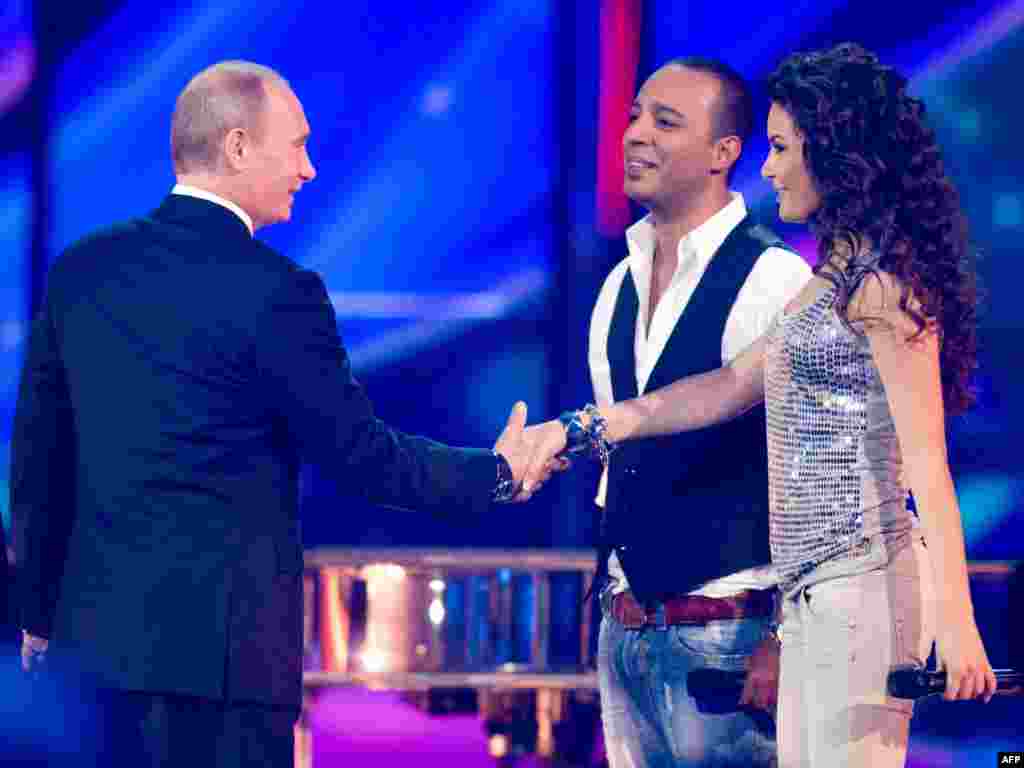 Russian President Vladimir Putin was seen as closely supervising Moscow's lavish preparations to host the competition in 2009. One analyst remarked that Putin saw Eurovision as a chance to promote "national dignity." Here, the president meets Azerbaijan's contenders, Arash (center) and AySel (right). 