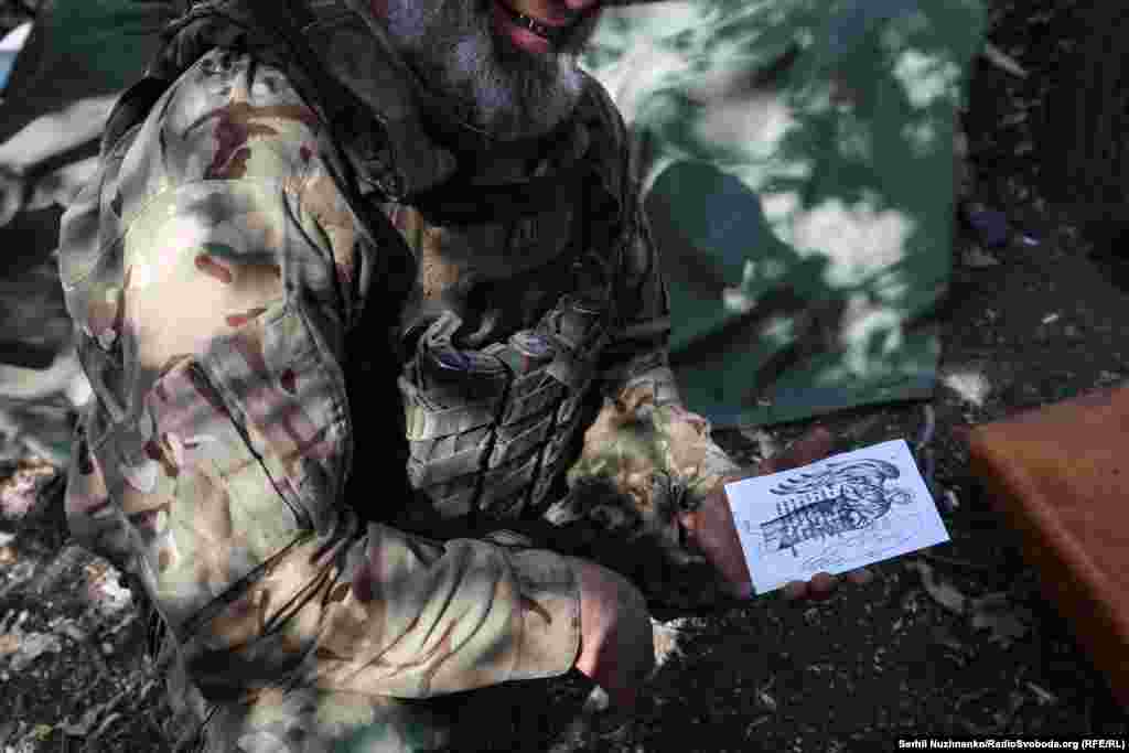 A member of an artillery crew near Pokrovsk shows the religious artwork he sketches between combat duties. Pokrovsk is a major railway hub and, crucially, produces high-quality coal needed in steel production. Industry experts say Ukraine could lose half of its current steelmaking capacity if the city and its nearby mine falls into Russian hands. 