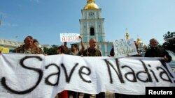 Demonstrators hold signs and banners demanding the release of Nadiya Savchenko, during a rally in Kyiv on July 11.