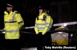British police stand guard beside a cordoned-off area in Salisbury.