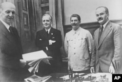 (Left to right:) German diplomat Friedrich Gaus, German Foreign Minister Joachim von Ribbentrop, Sovet leader Joseph Stalin, and Soviet Foreign Minister Vyacheslav Molotov in the Kremlin on August 23, 1939.
