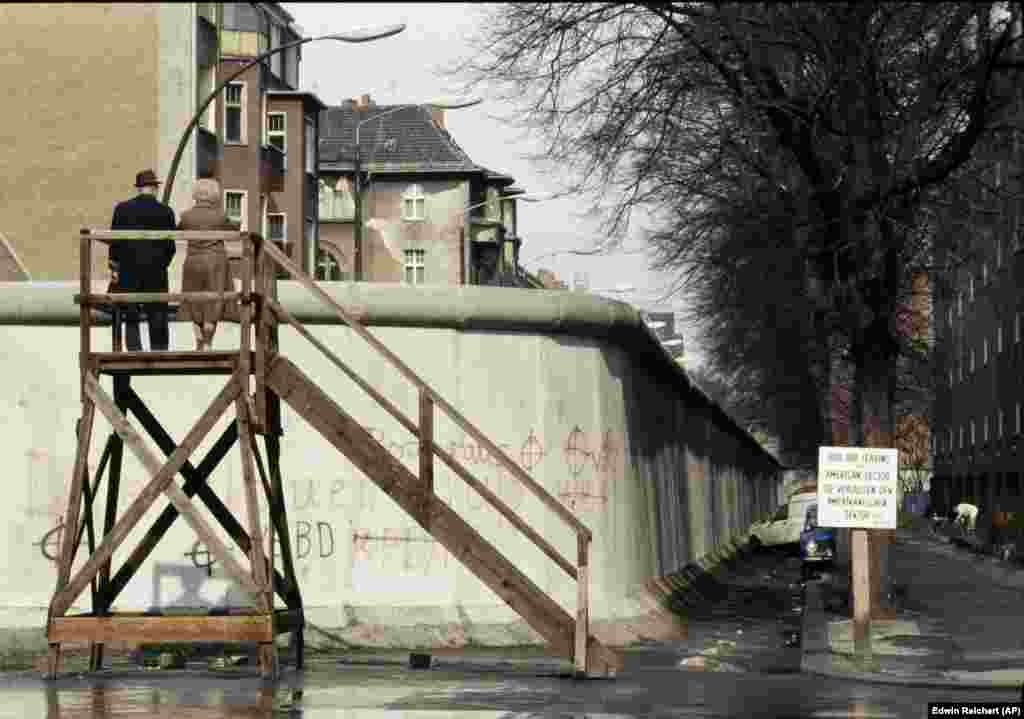 A couple look over the wall into East Berlin in April 1983. Salter says the testing of anti-vehicle barriers was only one part of a vast research-and-development effort to trap people inside the police state. The Berlin Wall design itself, he says, was trialled "for its resistance to attacks with vehicles, explosives, and how it would withstand natural events such as being washed away by water during heavy rainfall."