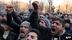 Armenian protesters shout slogans in front of the prosecutor's office in Gyumri.