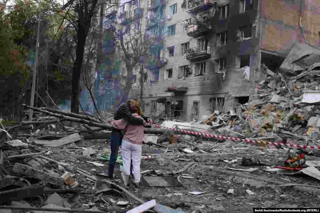People embrace amid the rubble following the attack.Russian strikes overnight hit multiple sites in Kyiv, and targeted the cities of Odesa and Zaporizhzhya, in Ukraine's south and east. One person was reported killed in Odesa.