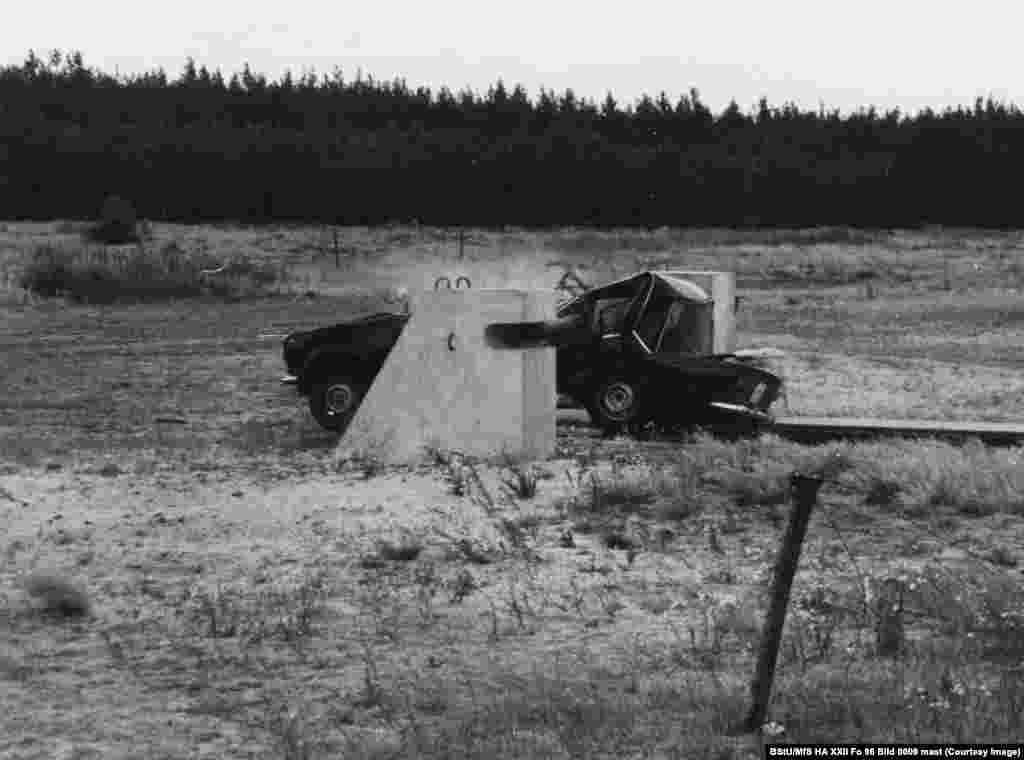 A vehicle smashes into a steel barrier at a secret testing location in East Germany where obstacles to prevent people speeding to freedom through East Berlin's checkpoints were tested. This 1980 photo is one of several held in Germany's Stasi Records Archive that reveal the lengths to which East Germany's authorities went to ensure anyone trying to escape the communist state would be stopped, or killed in the process.