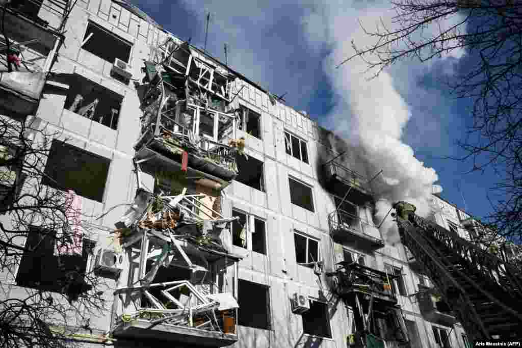 Firefighters work to put out a fire after bombings in the eastern Ukrainian town of Chuhuiv.