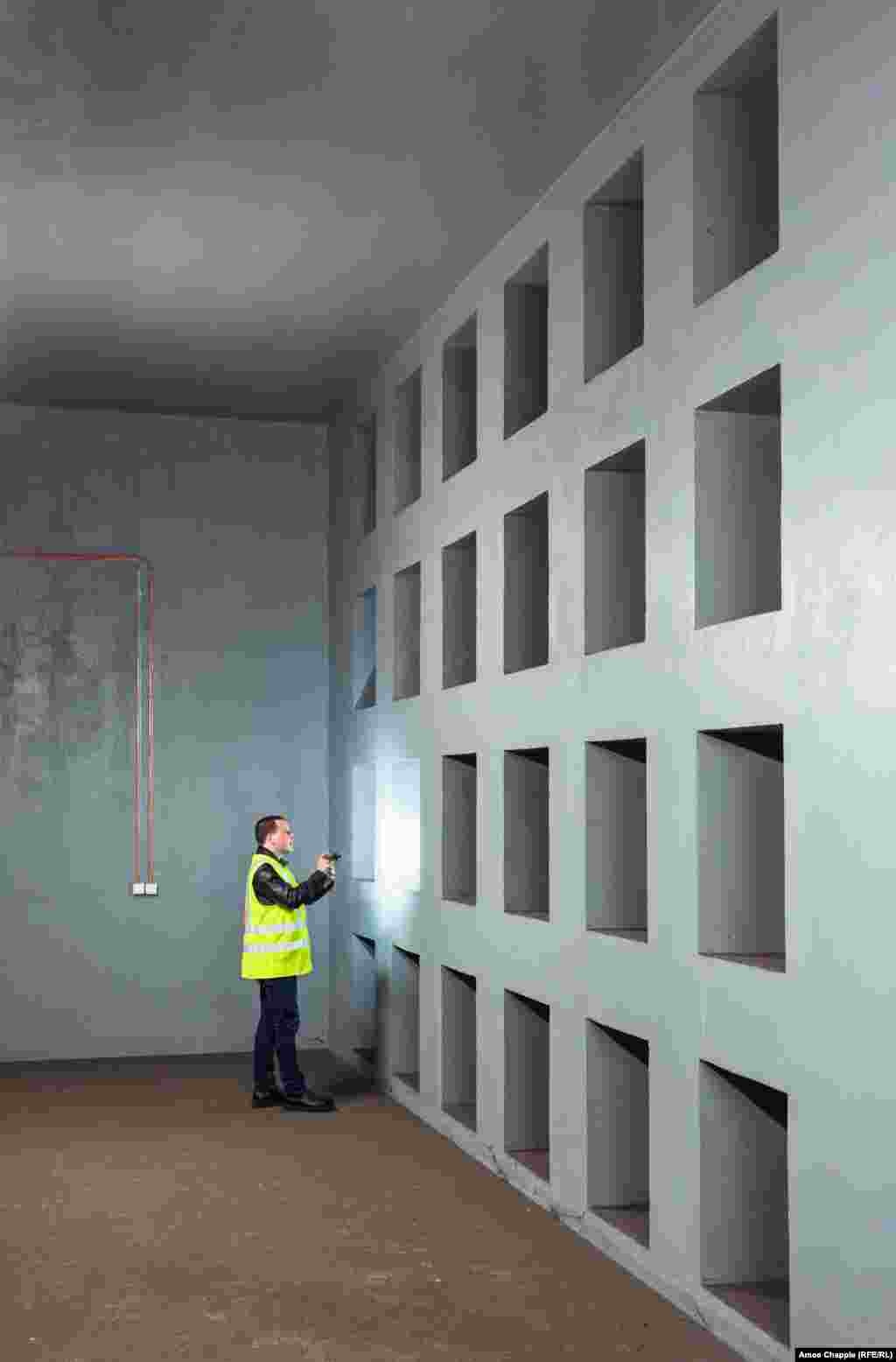 A subway worker inspects a wall of air filter intakes in the OSM. The network of shelters is designed to accommodate up to 320,000 people inside several specially equipped subway stations and the tunnels between them. 