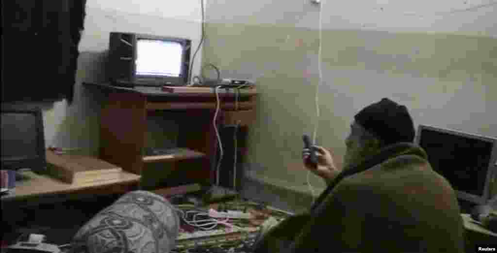Bin Laden watches himself on television, likely at his hideaway in Abbottabad, Pakistan, in an undated home video. The Islamist fugitive managed to evade both the bombs and the U.S. Special Forces when he slipped across the border into Pakistan.