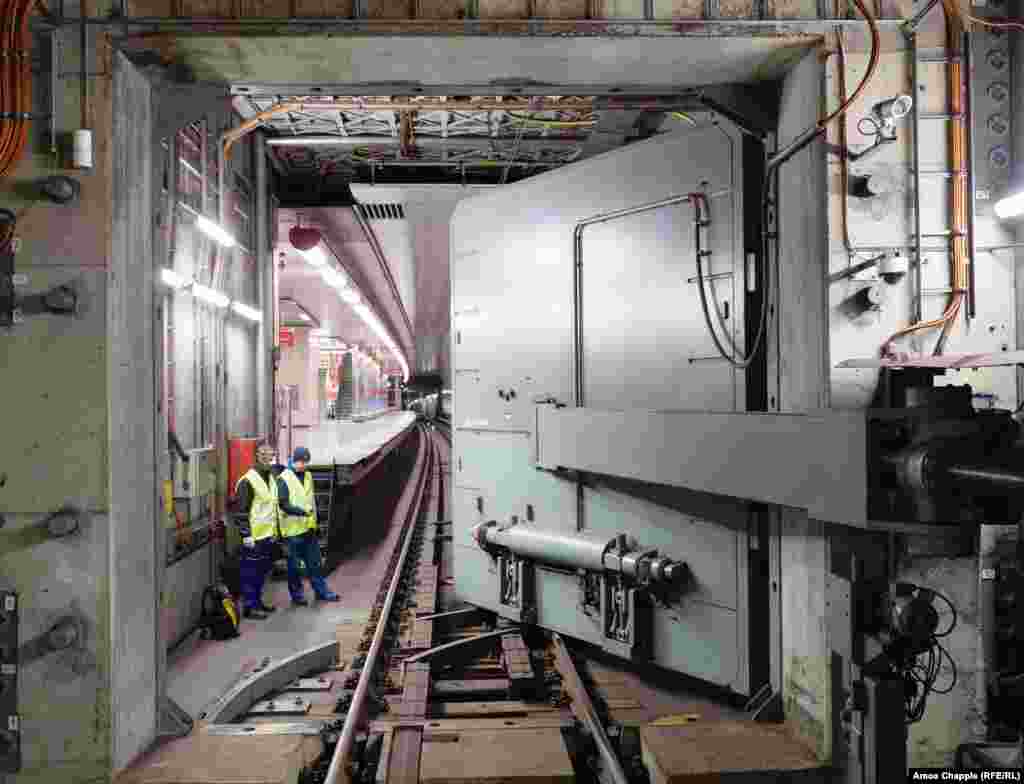 Engineers watch as the hermetically sealed blast door is closed over subway tracks. The OSM was built into Prague’s subway network beginning in 1974 when the specter of nuclear war was haunting Europe. 