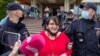 Former municipal deputy Yulia Galyamina in led out of the hotel in Novgorod on May 22. 